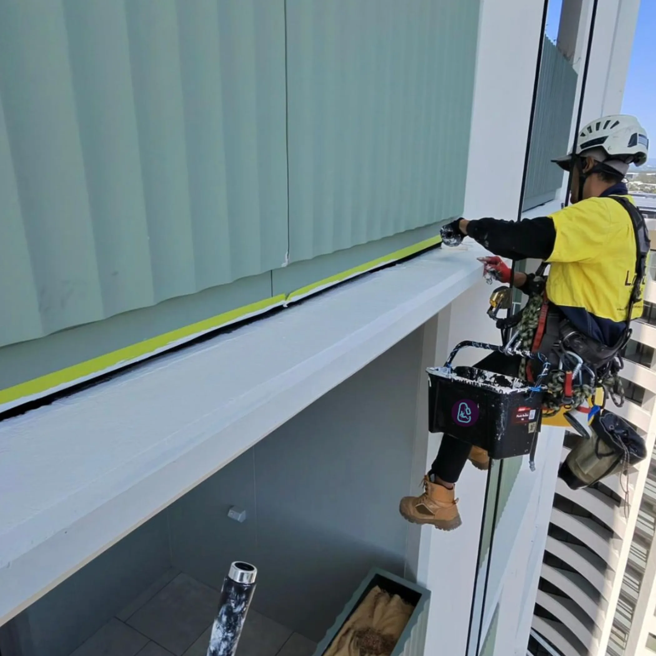 technician performing rope-access building maintenance
