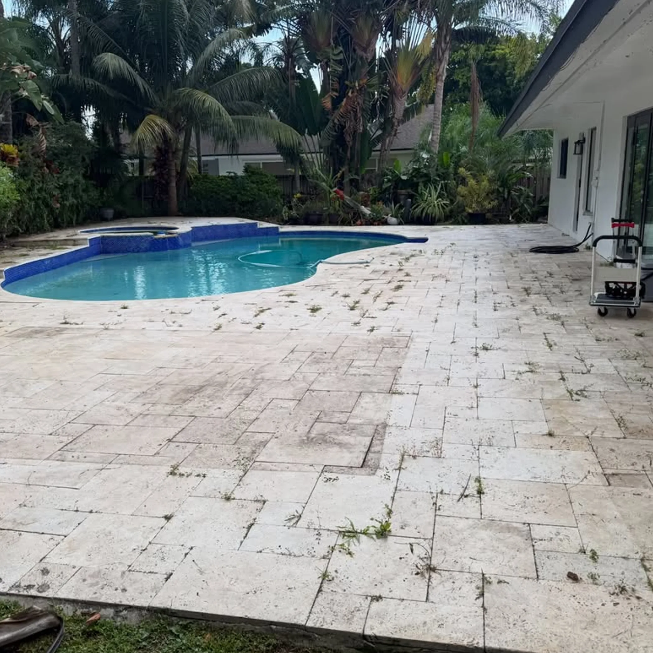 stone pool deck being pressure cleaned