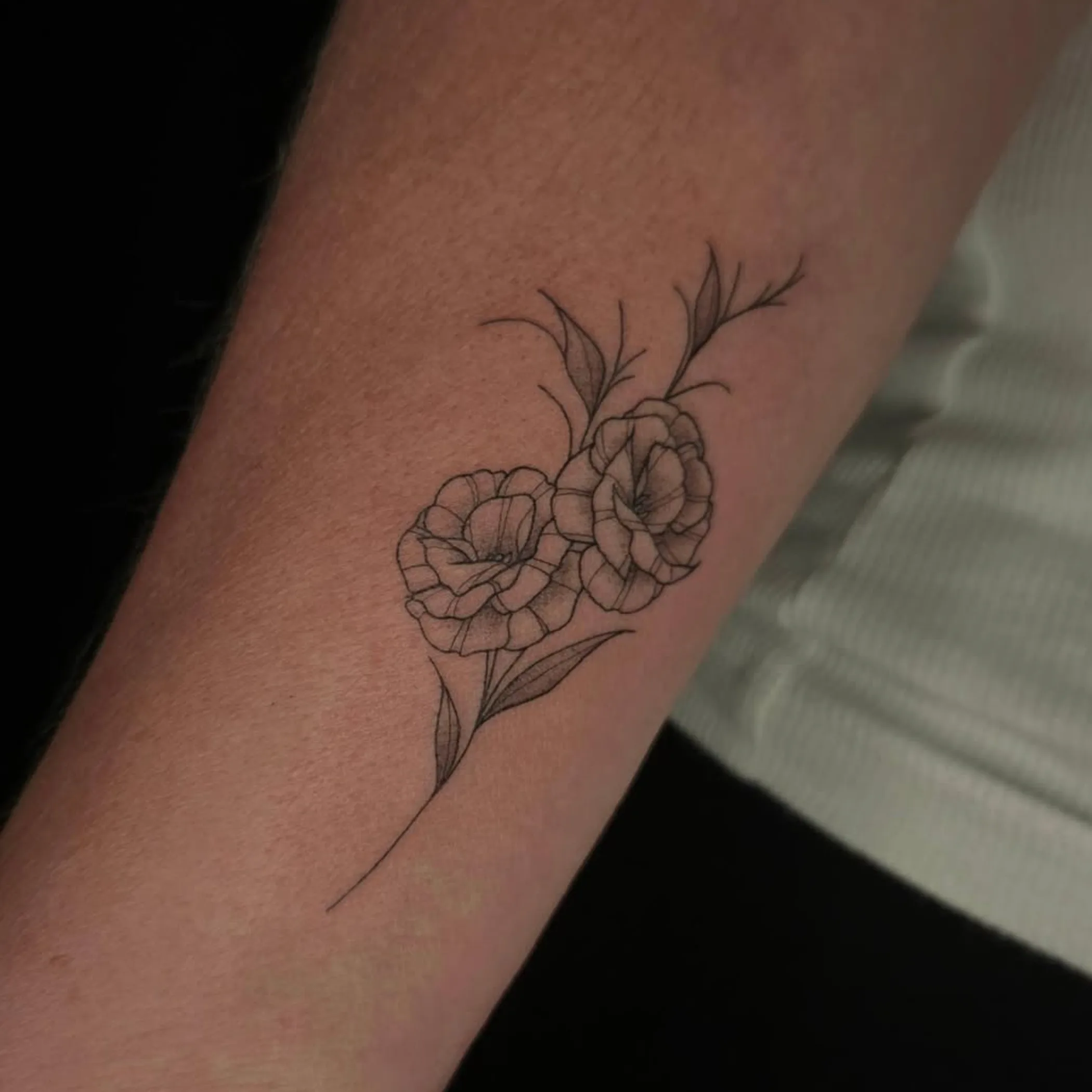 daisy-like floral tattoo